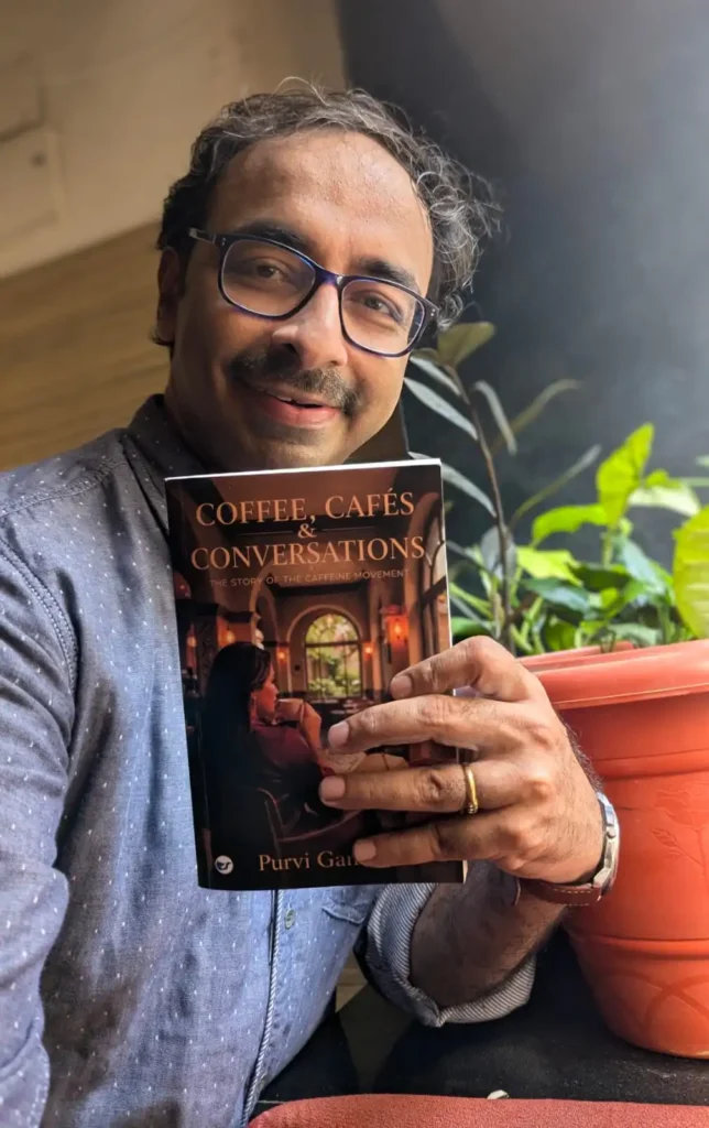 Sridhar with coffee book Executive Ghostwriter in India R Sridhar with his ghostwritten book Coffee, Cafes & Conversations by Purvi Gandhi